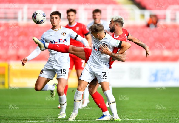 141023 - Swindon Town v Newport County - EFL SkyBet League 2 - Lewis Payne of Newport County is tackled by Charlie Austin of Swindon Town