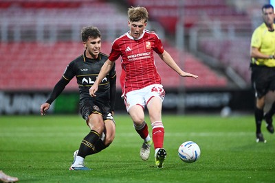 220926 - Swindon Town v Newport County - EFL Trophy -  Harri Pugh of Newport County is challenged by Freddie Hoare of Swindon