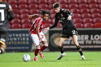 220926 - Swindon Town v Newport County - EFL Trophy -  Joe Thomas of Newport County is challenged by Antwoine Hackford of Swindon