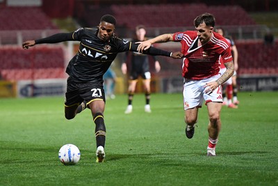 220926 - Swindon Town v Newport County - EFL Trophy -  Tanatswa Nyakuhwa of Newport County is challenged by Jaylan Pearman of Swindon