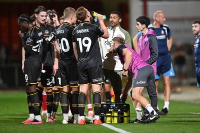 220926 - Swindon Town v Newport County - EFL Trophy -  Newport County Head Coach, Hayden Mullins speaks to his players during a water break