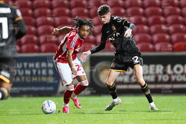 220926 - Swindon Town v Newport County - EFL Trophy -  Joe Thomas of Newport County is challenged by Antwoine Hackford of Swindon