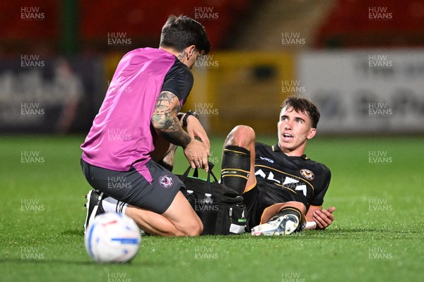 220926 - Swindon Town v Newport County - EFL Trophy -  Harri Pugh of Newport County leaves the filed injured