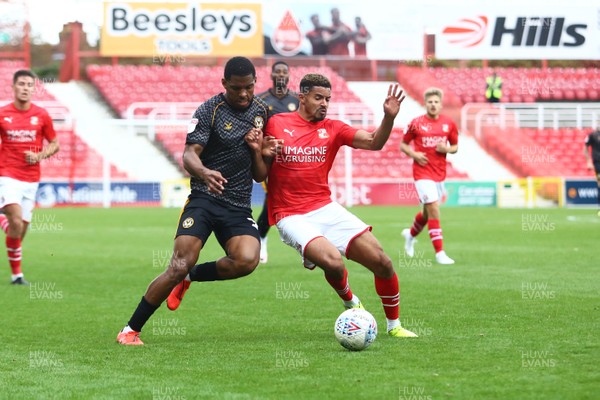 280919 - Swindon Town v Newport County - EFL SkyBet League 2 - Tristan Abrahams of Newport County and Zeki Fryers of Swindon Town compete for a ball  