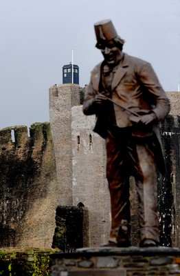 091209 - Doctor Who Filming - The Tardis sits on the tower at Caerphilly Castle, South Wales, near the statue of comedian Tommy Cooper who was born in the town