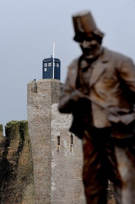 091209 - Doctor Who Filming - The Tardis sits on the tower at Caerphilly Castle, South Wales, near the statue of comedian Tommy Cooper who was born in the town