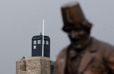 091209 - Doctor Who Filming - The Tardis sits on the tower at Caerphilly Castle, South Wales, near the statue of comedian Tommy Cooper who was born in the town