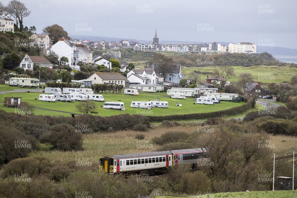 051020 - Picture shows a train passing the seaside town of Tenby, West Wales with a caravan and campsite in the foreground Welsh Health Minister Vaughan Gething today said the Welsh Government are considering imposing travel restrictions on coronavirus hotspots, which could stop travel to Wales from areas like the North East of England
