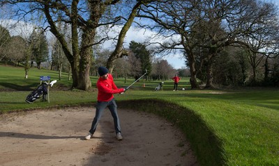 130321 Golf returns in Wales - One of the first players to take to the course plays a shot at Cardiff Golf Club on the day that lockdown restrictions were eased in Wales for outside sports including golf and tennis