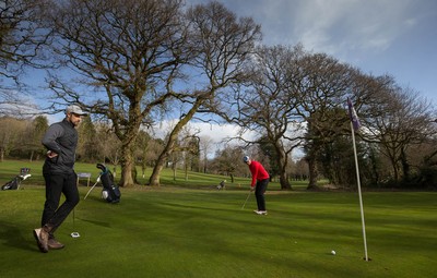 130321 Golf returns in Wales - One of the first players to take to the course plays a shot at Cardiff Golf Club on the day that lockdown restrictions were eased in Wales for outside sports including golf and tennis