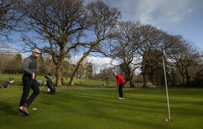 130321 Golf returns in Wales - One of the first players to take to the course plays a shot at Cardiff Golf Club on the day that lockdown restrictions were eased in Wales for outside sports including golf and tennis