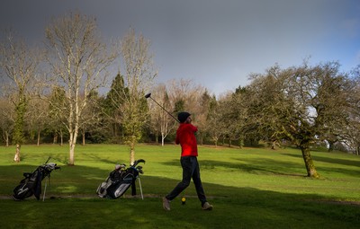130321 Golf returns in Wales - One of the first players to take to the course plays a shot at Cardiff Golf Club on the day that lockdown restrictions were eased in Wales for outside sports including golf and tennis