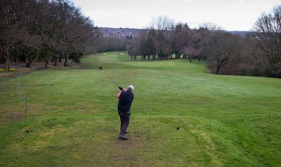 130321 Golf returns in Wales - One of the first players to take to the course plays a shot at Cardiff Golf Club on the day that lockdown restrictions were eased in Wales for outside sports including golf and tennis