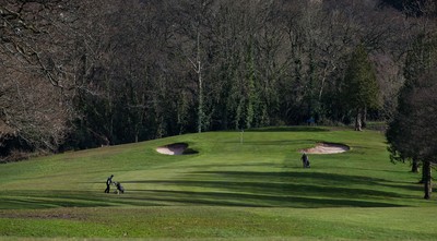 130321 Golf returns in Wales - One of the first players to take to the course plays a shot at Cardiff Golf Club on the day that lockdown restrictions were eased in Wales for outside sports including golf and tennis
