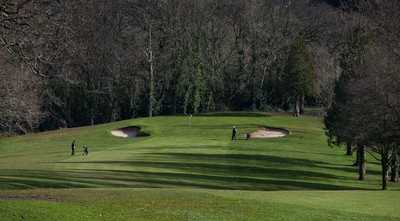 130321 Golf returns in Wales - One of the first players to take to the course plays a shot at Cardiff Golf Club on the day that lockdown restrictions were eased in Wales for outside sports including golf and tennis