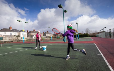 130321 Golf and Tennis return in Wales - Sara Davies, aged 10 from Cardiff, has her first tennis lesson in over 3 months from Head Coach Melissa Davies at Whitchurch Tennis Club in Cardiff on the day that lockdown restrictions were eased in Wales for outside sports including golf and tennis