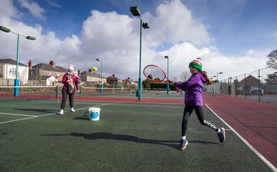 130321 Golf and Tennis return in Wales - Sara Davies, aged 10 from Cardiff, has her first tennis lesson in over 3 months from Head Coach Melissa Davies at Whitchurch Tennis Club in Cardiff on the day that lockdown restrictions were eased in Wales for outside sports including golf and tennis
