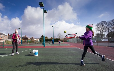 130321 Golf and Tennis return in Wales - Sara Davies, aged 10 from Cardiff, has her first tennis lesson in over 3 months from Head Coach Melissa Davies at Whitchurch Tennis Club in Cardiff on the day that lockdown restrictions were eased in Wales for outside sports including golf and tennis