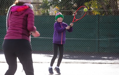 130321 Golf and Tennis return in Wales - Sara Davies, aged 10 from Cardiff, has her first tennis lesson in over 3 months from Head Coach Melissa Davies at Whitchurch Tennis Club in Cardiff on the day that lockdown restrictions were eased in Wales for outside sports including golf and tennis