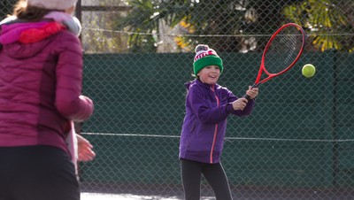 130321 Golf and Tennis return in Wales - Sara Davies, aged 10 from Cardiff, has her first tennis lesson in over 3 months from Head Coach Melissa Davies at Whitchurch Tennis Club in Cardiff on the day that lockdown restrictions were eased in Wales for outside sports including golf and tennis