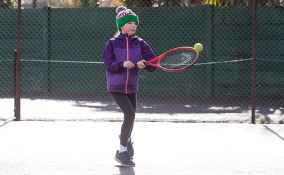 130321 Golf and Tennis return in Wales - Sara Davies, aged 10 from Cardiff, has her first tennis lesson in over 3 months from Head Coach Melissa Davies at Whitchurch Tennis Club in Cardiff on the day that lockdown restrictions were eased in Wales for outside sports including golf and tennis