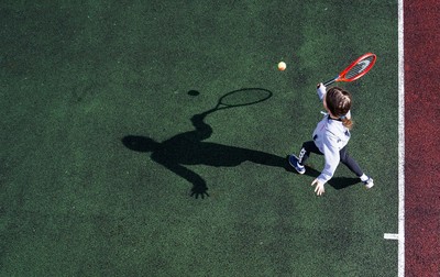 130321 Golf and Tennis return in Wales - Sara Davies, aged 10 from Cardiff, has her first tennis lesson in over 3 months from Head Coach Melissa Davies at Whitchurch Tennis Club in Cardiff on the day that lockdown restrictions were eased in Wales for outside sports including golf and tennis