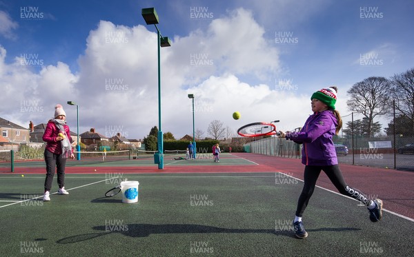 130321 Golf and Tennis return in Wales - Sara Davies, aged 10 from Cardiff, has her first tennis lesson in over 3 months from Head Coach Melissa Davies at Whitchurch Tennis Club in Cardiff on the day that lockdown restrictions were eased in Wales for outside sports including golf and tennis