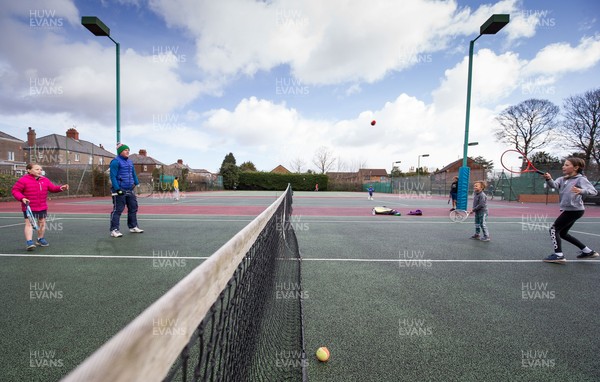 130321 Golf and Tennis return in Wales - The Davies family from Cardiff, enjoy their first tennis session in over 3 months at Whitchurch Tennis Club in Cardiff on the day that lockdown restrictions were eased in Wales for outside sports including golf and tennis