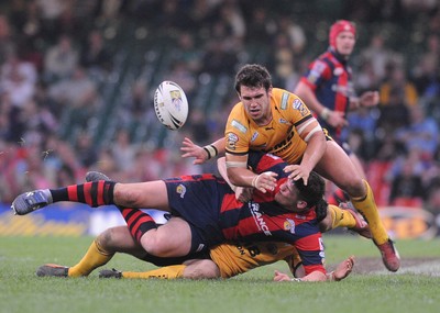 03.04.08 - Millennium Magic 2008 Rugby League Castleford Tigers v Wakefield Trinity Wildcats Wildcats' Kyle Bibb releases the ball as he is tackled 