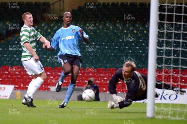 280803 - The New Saints (TNS) v Manchester City - UEFA Cup Qualifying Round - Man City's Christian Negouai puts the ball past TNS goalkeeper Dean Williams as Christopher Taylor (left) looks on