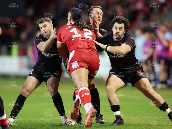 241022 - Tonga v Wales - Rugby League World Cup 2021 - Rhys Williams of Wales Rugby League stops Keaon Koloamatangi of Tonga RL