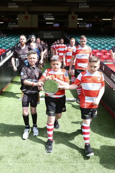 300422 - Tonna v Crumlin - WRU National Shield Final - Mascots lead the teams out with the trophy
