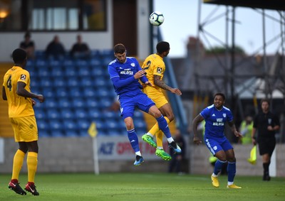 200718 - Torquay v Cardiff City - Preseason Friendly - Gary Madine of Cardiff City competes with Ben Winter of Torquay