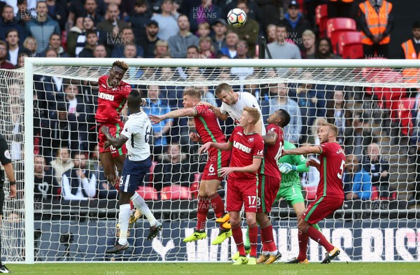 160917 - Tottenham Hotspur v Swansea City - Premier League - Tammy Abraham of Swansea City gets up (L) to head clear