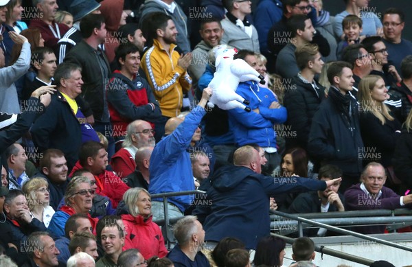 160917 - Tottenham Hotspur v Swansea City - Premier League - A defiant Swansea supporter waves a blow up sheep at Spurs supporters