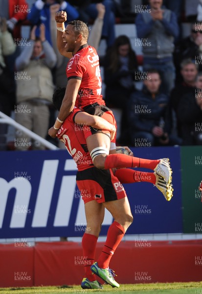 120113 - Toulon v Cardiff Blues - Heineken Cup -Maxime Mermoz of Toulon celebrates his try with Delon Armitage(top)