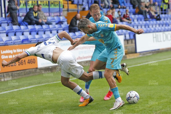 210821 - Tranmere Rovers v Newport County - Sky Bet League 2 - Nathaniel Knight-Percival of Tranmere Rovers pulls at Cameron Norman of Newport County with Robbie Willmott of Newport County in attendance