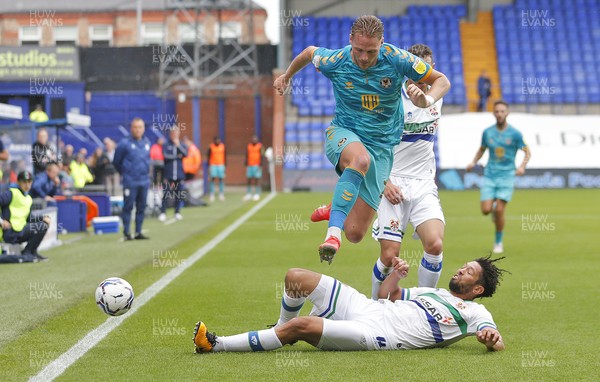 210821 - Tranmere Rovers v Newport County - Sky Bet League 2 - Cameron Norman of Newport County tries to hold back Nathaniel Knight-Percival of Tranmere Rovers and Kieron Morris of Tranmere Rovers