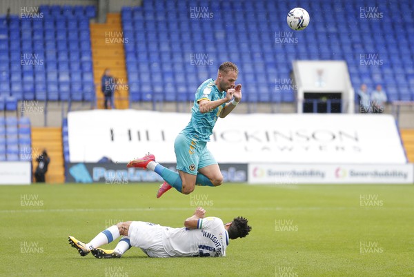 210821 - Tranmere Rovers v Newport County - Sky Bet League 2 - Cameron Norman of Newport County leaps over Nathaniel Knight-Percival of Tranmere Rovers