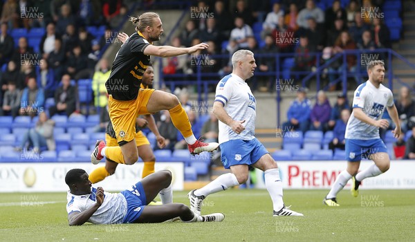 220918 - Tranmere Rovers v Newport County - Sky Bet League 2 - Frazier Frands of Newport County scores the 1st goal of the match in the 1st 5 mins and leaps over Zoumana Bakayogo of Tranmere Rovers to celebrate 