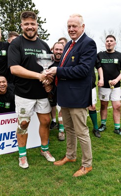 260425 - Tredegar Ironsides v Magor - Admiral National League 5 East - Colin Wilks of the WRU presents the league trophy to club captain Zac Davies