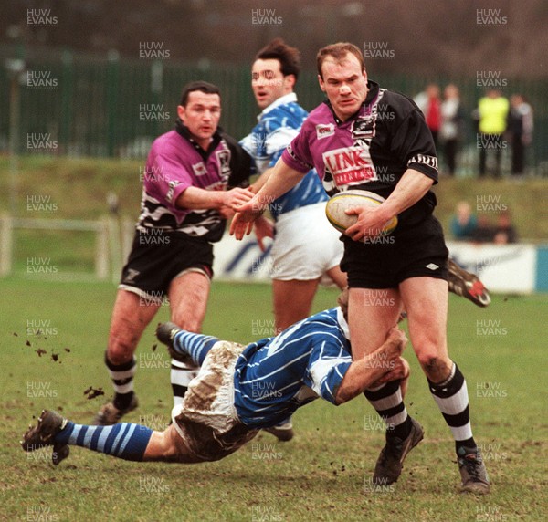 010397 - Treorchy v Bridgend - SWALEC Cup - Simon Davies of Treorchy is tackled by Gareth Thomas