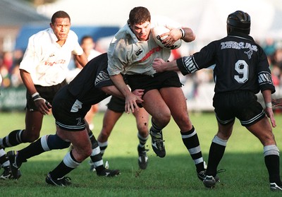 011195 - Treorchy v Fiji - Dan Rouse of is tackled by Nick Jones and Carl Hamans