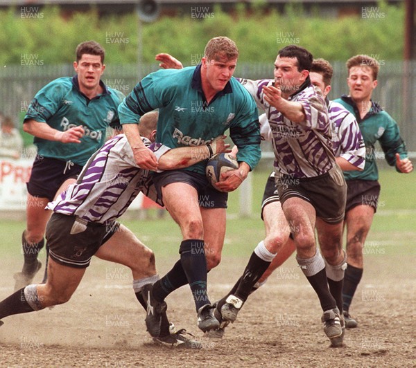 110596 - Treorchy v Neath - Leigh Davies of Neath is tackled by Paul Jones (left) and David Evans