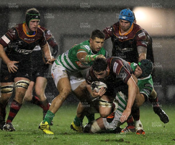 190216 - Treviso v Dragons - Guinness Pro 12 -Dragons' Cory Hill is tackled by Treviso's Dean Budd and Andrea De Marchi