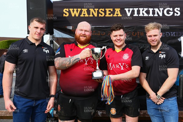 150423 - UK International Gay Rugby Grand Finals - Captain Jacob Mills and Head Coach Hwyel James of Cardiff Lions receive the League Cup from Morgan Morse and Mathew Protheroe of Ospreys