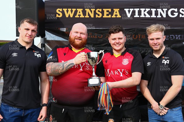 150423 - UK International Gay Rugby Grand Finals - Captain Jacob Mills and Head Coach Hwyel James of Cardiff Lions receive the League Cup from Morgan Morse and Mathew Protheroe of Ospreys