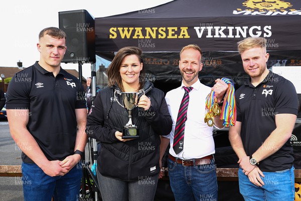 150423 - UK International Gay Rugby Grand Finals - Head Coach Sasha Acheson and captain Daryn McCombe of Bristol Bisons receive the Grand Final Development League Cup from Morgan Morse and Mathew Protheroe  of Ospreys