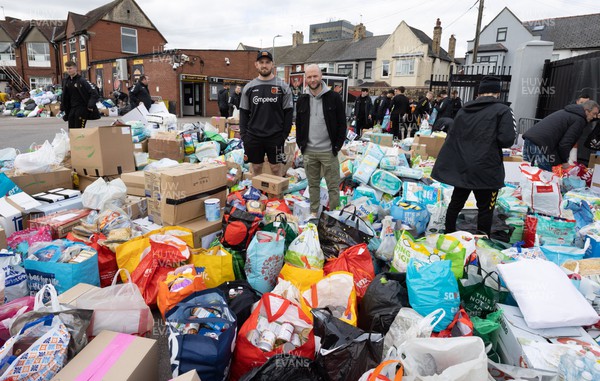 070322 Dragons captain Harri Keddie and Newport County manager James Rowberry along with players and staff join forces to help sort the large number of items donated to help those affected by the conflict in Ukraine