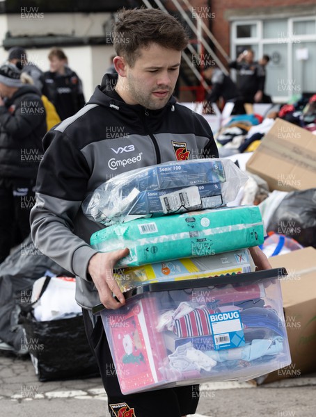 070322 Dragons and Newport County players and staff join forces to help sort the large number of items donated to help those affected by the conflict in Ukraine